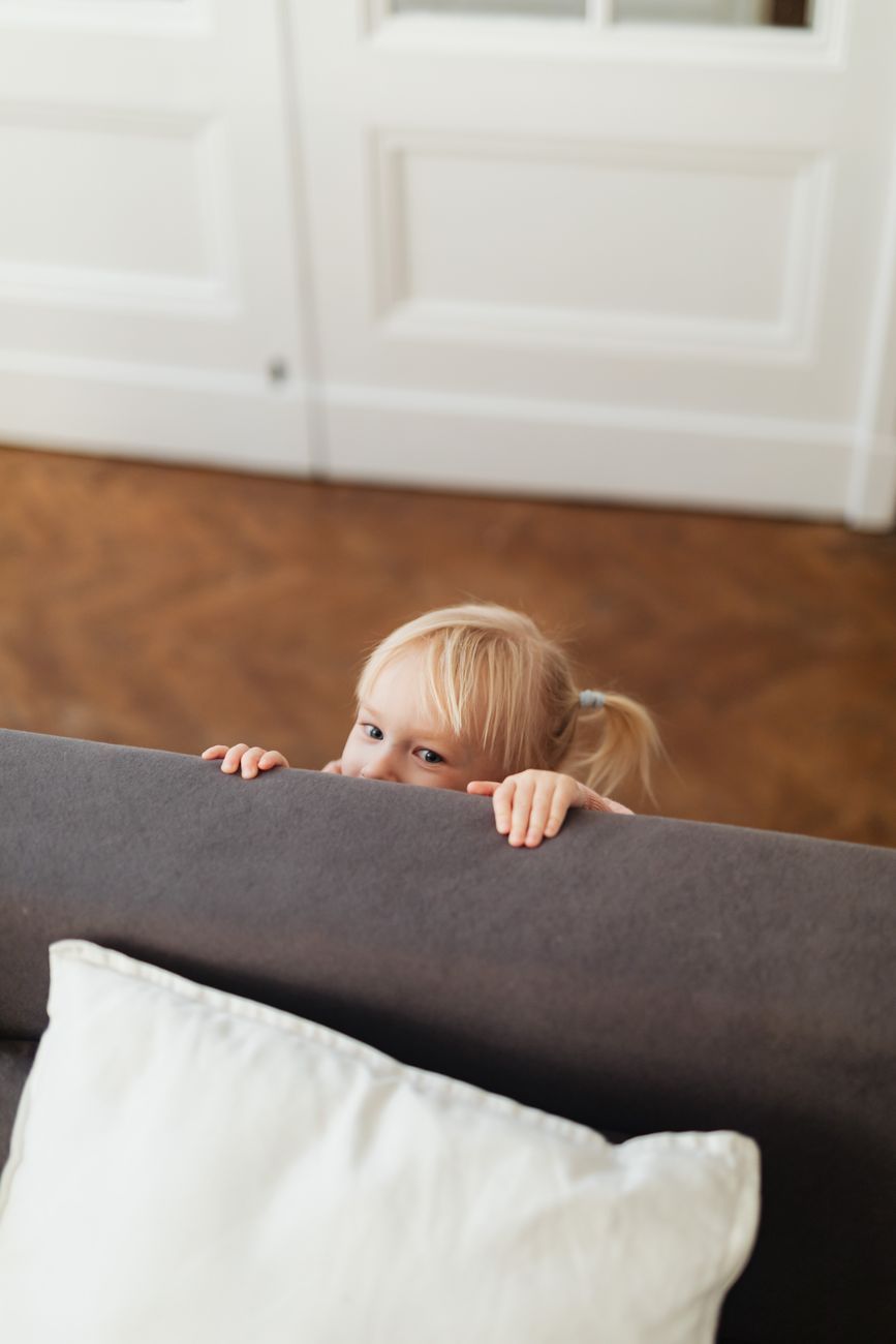 children hiding behavior, child psychology, why kids hide, imaginative play in children, child development stages, emotional security in kids, hide and seek psychology, children's independence, social development in children, parenting insights
